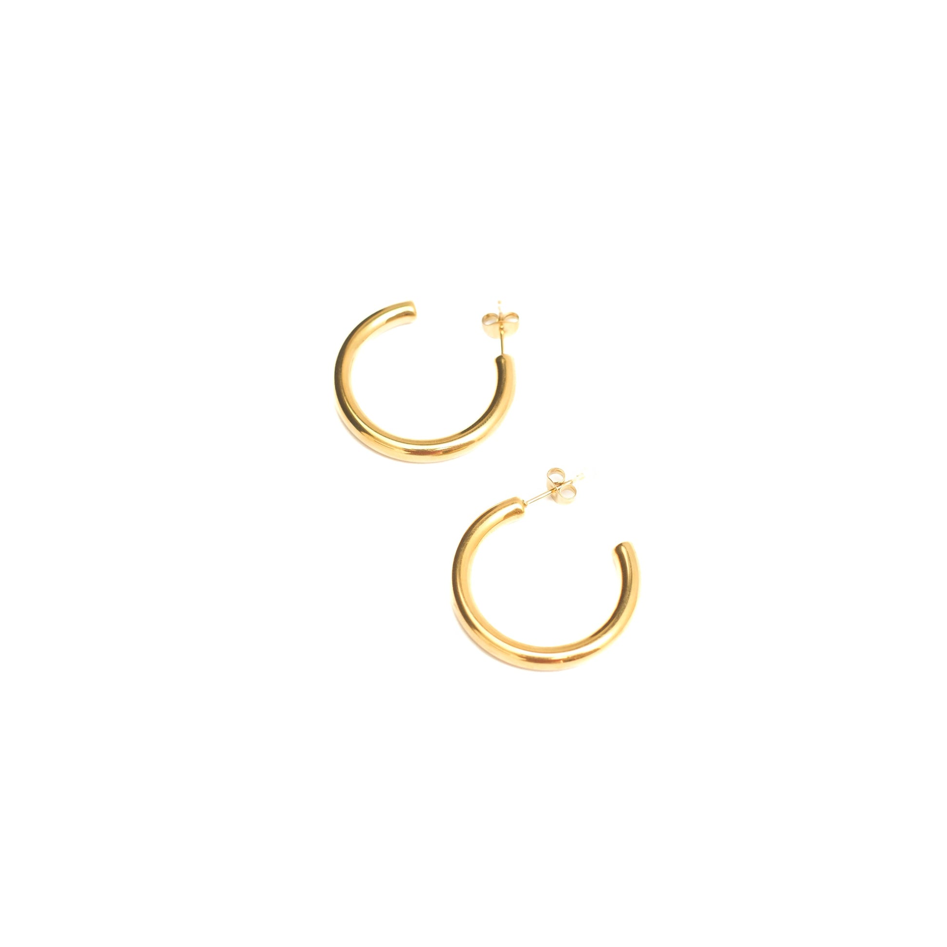 Gold hoop earrings on a white background